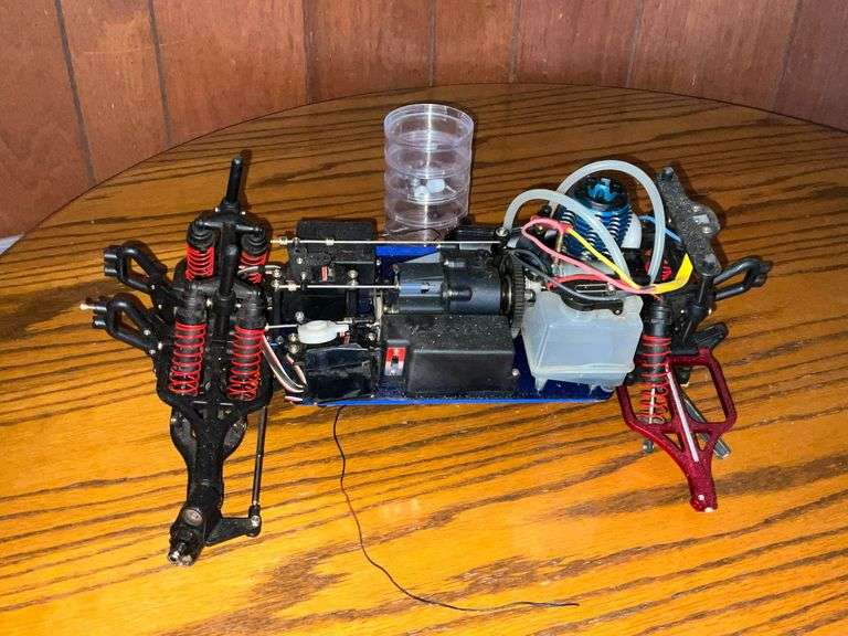 Traxxas 4-wheel drive car chassis with engine and radio receiver image