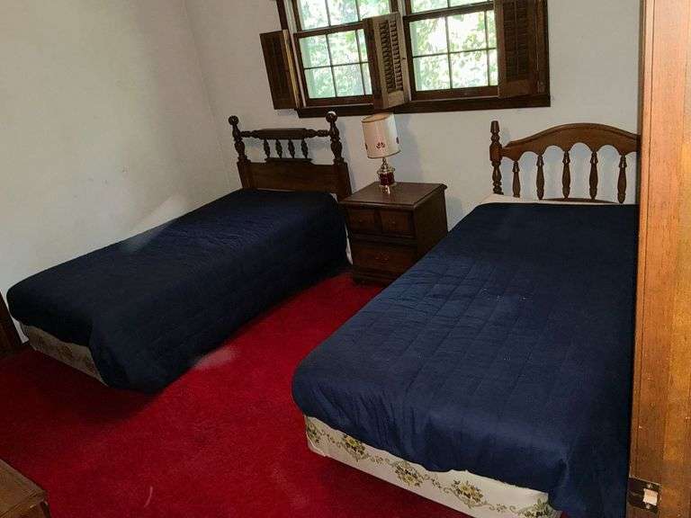 Pair of twin beds, night stand and lamp image