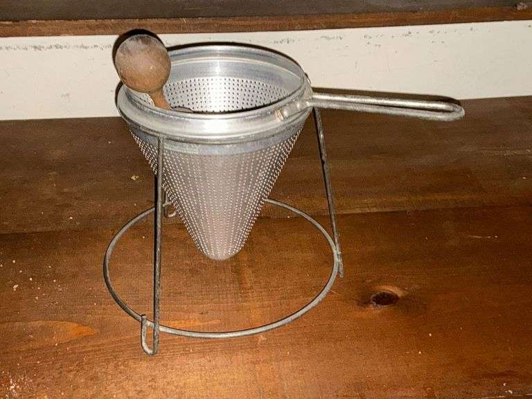 Food mill with stand and wooden pestle image