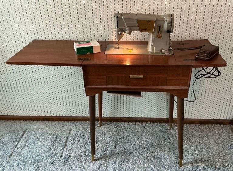 Singer sewing machine in cabinet, working condition image