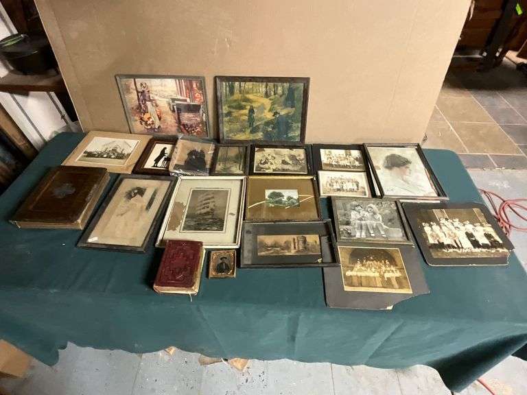 Old photographs, artwork, photo albums, some framed. image