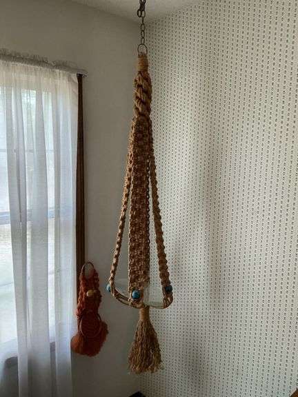 Macrame plant holder and wall hanger. image