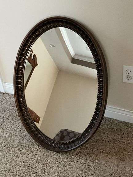 Oval plastic framed mirror image