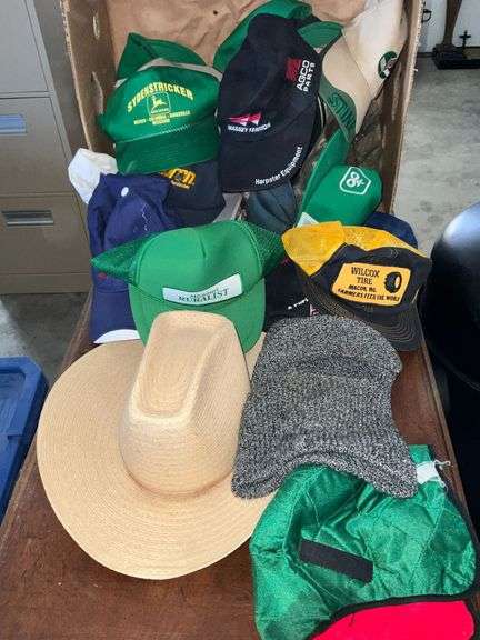 Assortment of ballcaps, straw hat, stocking cap image