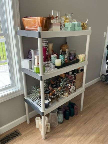 Plastic shelf with candles, candle sticks, air fresheners image