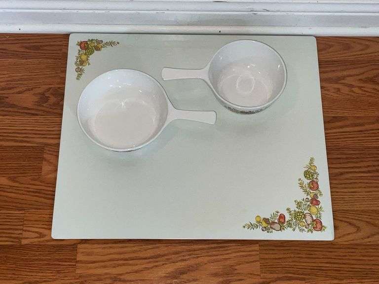 Corningware sauce pans with stove and counter mat image