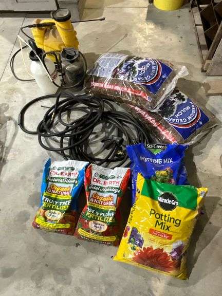 Miracle-Gro potting mix, cedar mulch, garden hose, spray tanks image