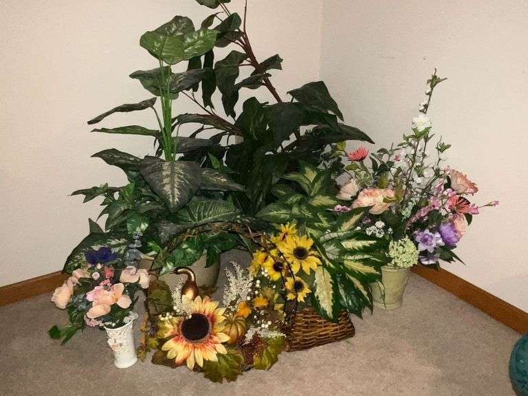 Assortment of artificial flowers and planters