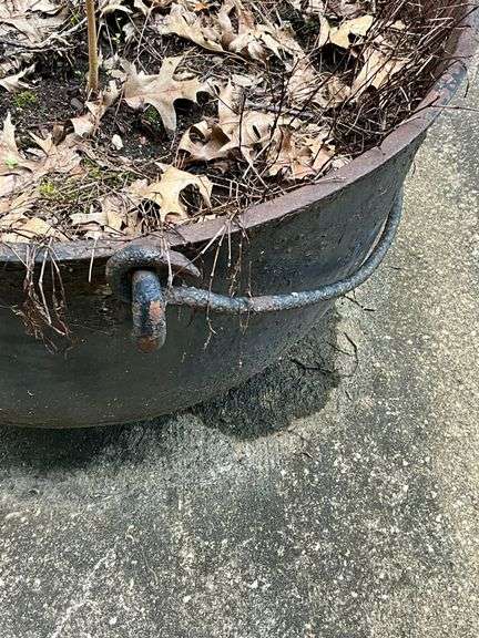 Cast iron kettle, has drain holes, 29" W