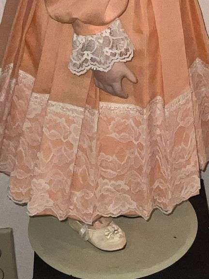 Porcelain doll in peach dress on stand, 24" T