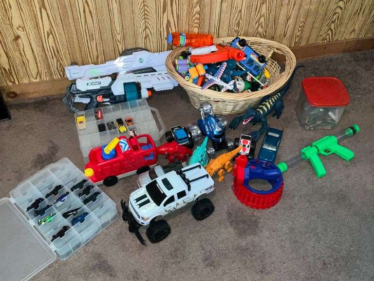 Assortment of toys, Nerf guns, cars, trucks image
