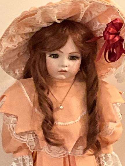 Porcelain doll in peach dress on stand, 24" T
