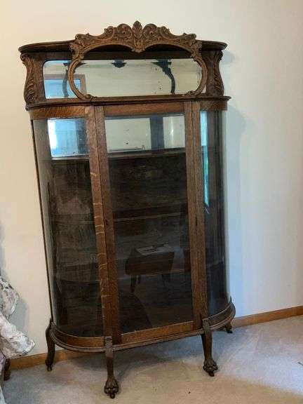 Antique china hutch with beveled mirror on top, paw feet and key