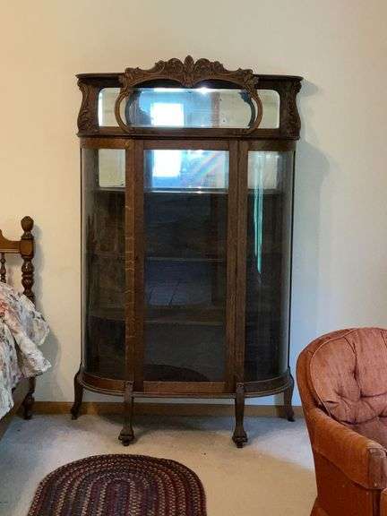 Antique china hutch with beveled mirror on top, paw feet and key