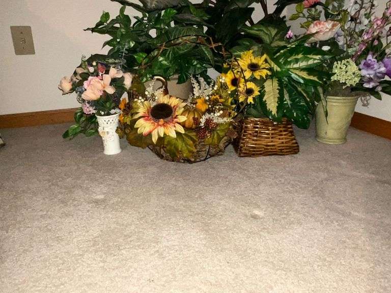 Assortment of artificial flowers and planters