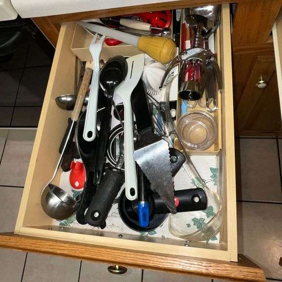 Assortment of kitchen utensils, corkscrew, spatulas, spoons, spaghetti server, juicer