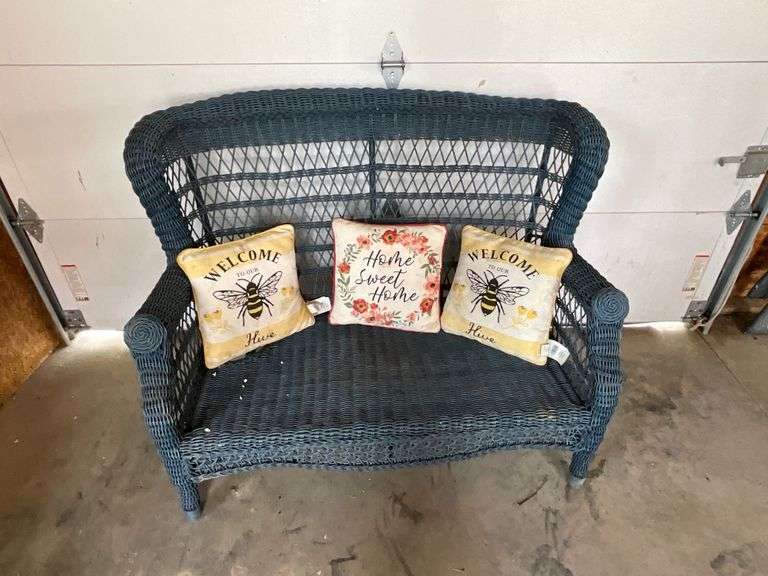 Wicker loveseat with throw pillows