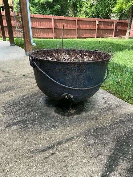 Cast iron kettle, has drain holes, 29" W