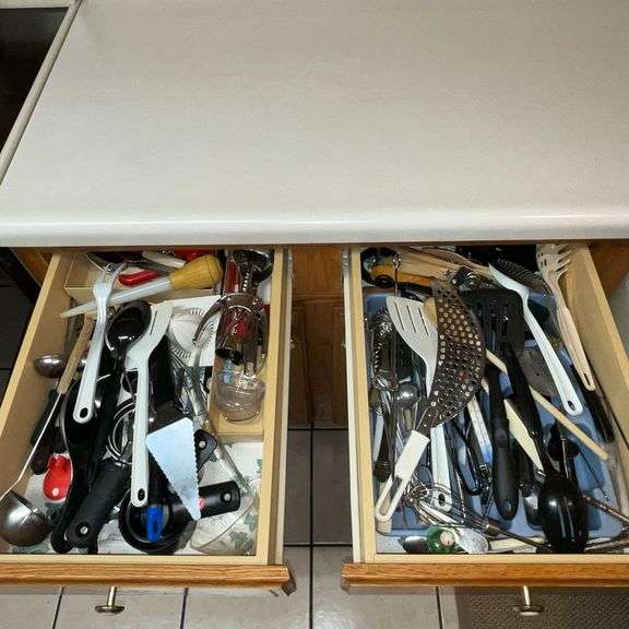 Assortment of kitchen utensils, corkscrew, spatulas, spoons, spaghetti server, juicer