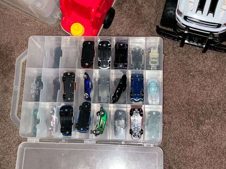 Assortment of toys, Nerf guns, cars, trucks