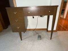 Universal DeLuxe sewing machine in cabinet Model G.B. with accessories