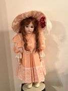Porcelain doll in peach dress on stand, 24" T