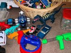 Assortment of toys, Nerf guns, cars, trucks