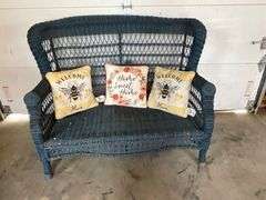 Wicker loveseat with throw pillows