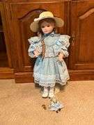 Porcelain doll on stand, 24" T