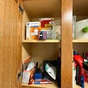 Contents of laundry room, cleaning supplies, light bulbs, ironing board