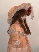 Porcelain doll in peach dress on stand, 24" T