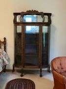 Antique china hutch with beveled mirror on top, paw feet and key