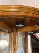 Lighted corner curio cabinet with glass shelves, paw feet, mirrored back