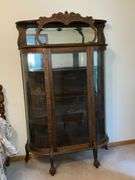 Antique china hutch with beveled mirror on top, paw feet and key