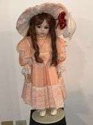 Porcelain doll in peach dress on stand, 24" T