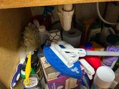 Assortment of cleaning supplies under the sink