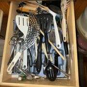 Assortment of kitchen utensils, corkscrew, spatulas, spoons, spaghetti server, juicer