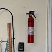 Snow shovel, rake, mop, yard sticks, trash bags, ice melt, galvanized trash can, fire extinguisher