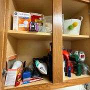 Contents of laundry room, cleaning supplies, light bulbs, ironing board