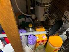 Assortment of cleaning supplies under the sink