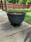 Cast iron kettle, has drain holes, 29" W