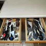 Assortment of kitchen utensils, corkscrew, spatulas, spoons, spaghetti server, juicer