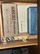 Universal DeLuxe sewing machine in cabinet Model G.B. with accessories