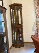 Lighted curio cabinet with glass shelves and mirrored back