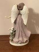 Angel with lilies and roses statue