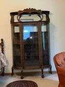 Antique china hutch with beveled mirror on top, paw feet and key