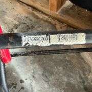Two-wheel hand truck, missing a wheel