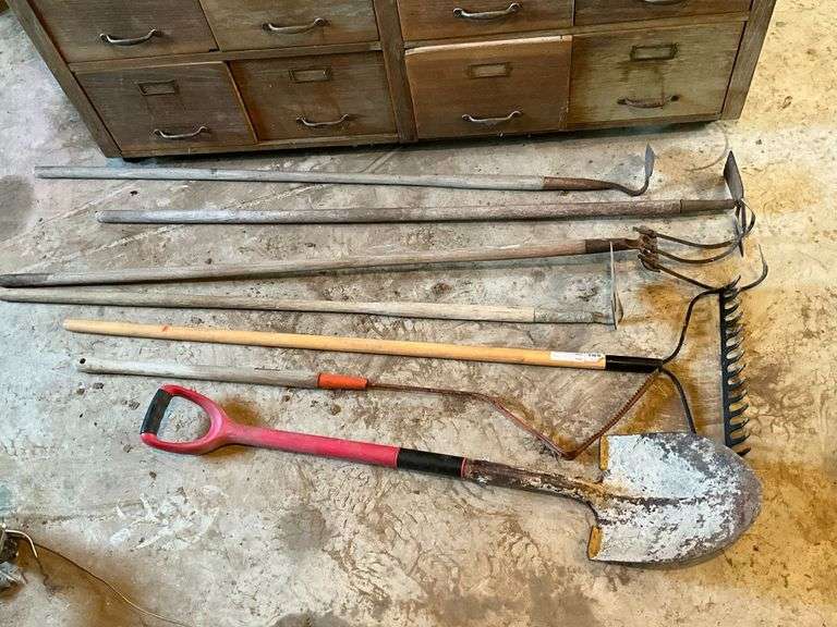 Long handle garden tools, rake, hoe, scythe, shovels and others. image