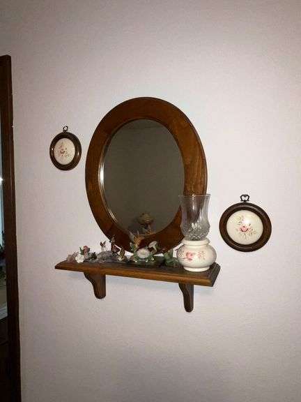Oval mirror with small shelf and decorations image