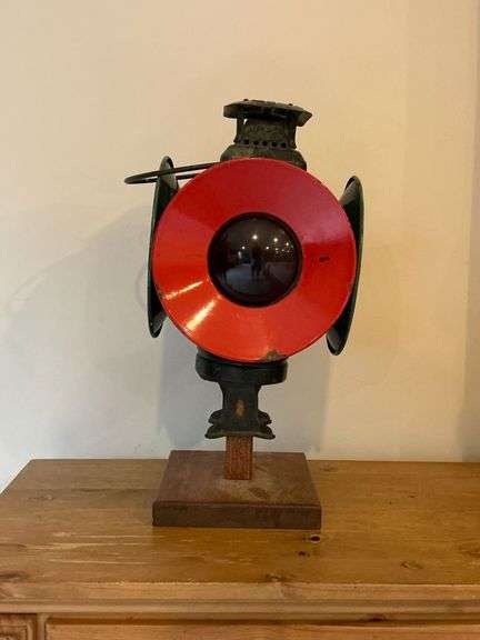 The Adlake Non-Sweating Lamp Railroad Lantern with red and blue lenses on wooden stand image